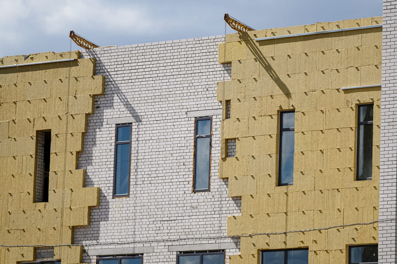 Sheathing of the outer wall of the building with insulation.Building facade insulation. Exterior finish
